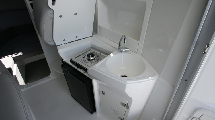 Galley with sink, storage lockers and dedicated space for refrigerator and gas stove installation